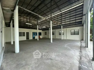 Spacious industrial warehouse with high ceilings and open floor plan, ideal for storage or manufacturing.