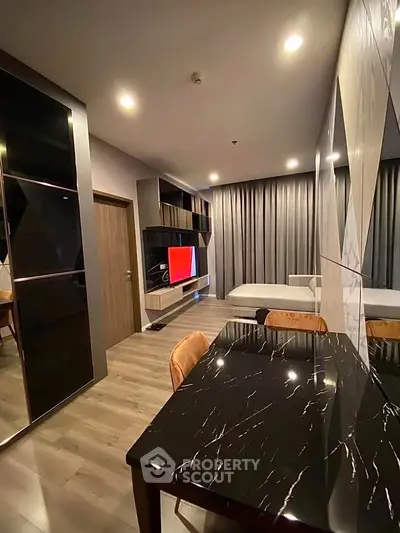 Modern studio apartment with sleek design and luxurious finishes, featuring a stylish living area and elegant furnishings.