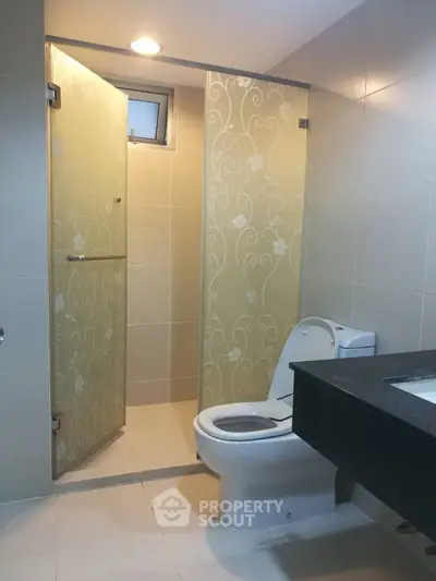 Modern bathroom with elegant glass shower doors and sleek fixtures