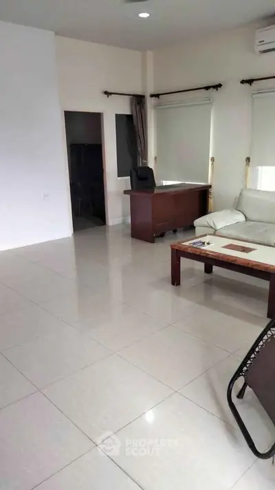Spacious living room with modern furniture and large windows for natural light.