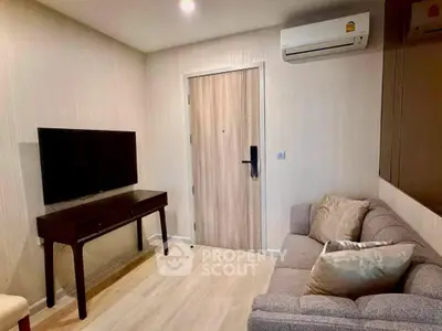 Cozy living room with modern decor and air conditioning in a stylish apartment.