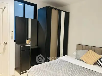 Modern bedroom with sleek wardrobe and cozy bedding in stylish apartment.