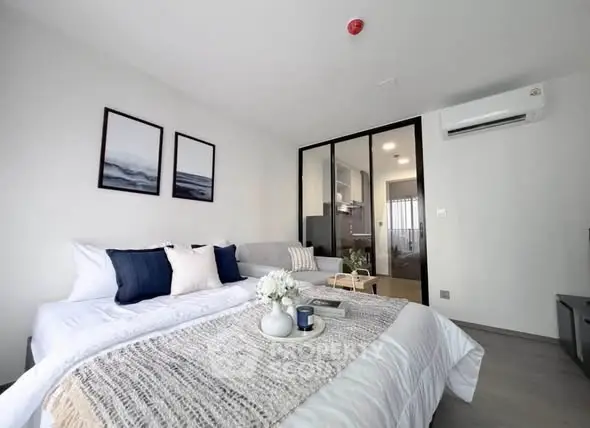 Modern bedroom with stylish decor and cozy ambiance in a contemporary apartment.