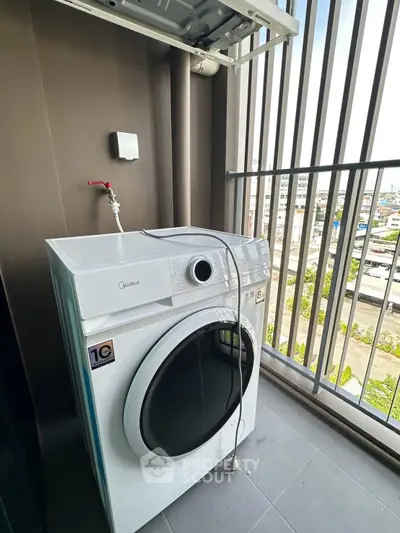 Modern balcony with washing machine and city view, perfect for urban living convenience.