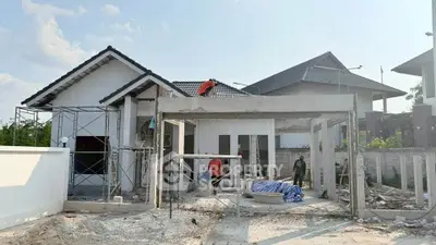 Modern house under construction with scaffolding and workers, showcasing potential for customization and design.