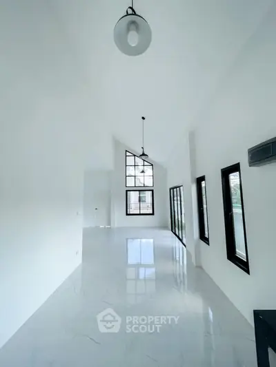 Spacious modern living room with high ceilings and large windows