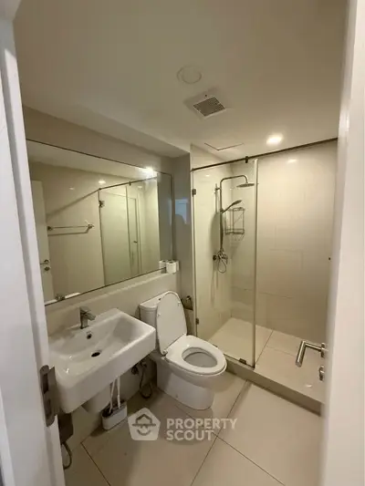 Modern bathroom with glass shower and sleek fixtures