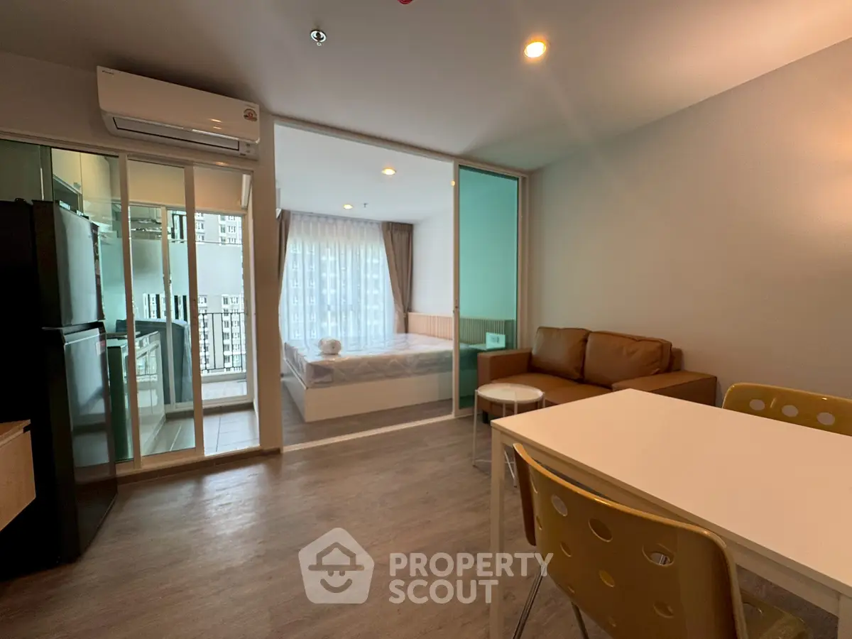 Modern studio apartment with open layout and balcony view