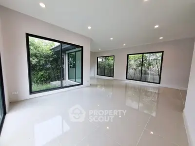 Spacious modern living room with large windows and garden view