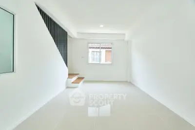 Bright minimalist interior with staircase and window, perfect for modern living.