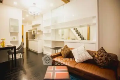 Modern open-layout living room with stylish kitchen and cozy seating area.