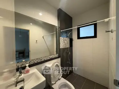 Modern bathroom with sleek fixtures and stylish tile accents in a contemporary home.