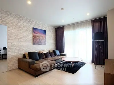 Modern living room with stylish decor and large windows for natural light.