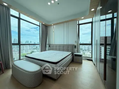 Luxurious bedroom with panoramic city views and modern decor