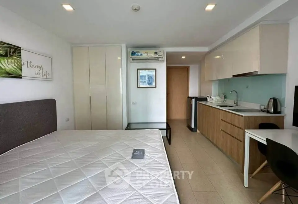 Modern studio apartment with kitchenette and cozy furnishings