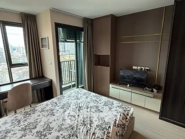 Modern bedroom with city view and balcony access