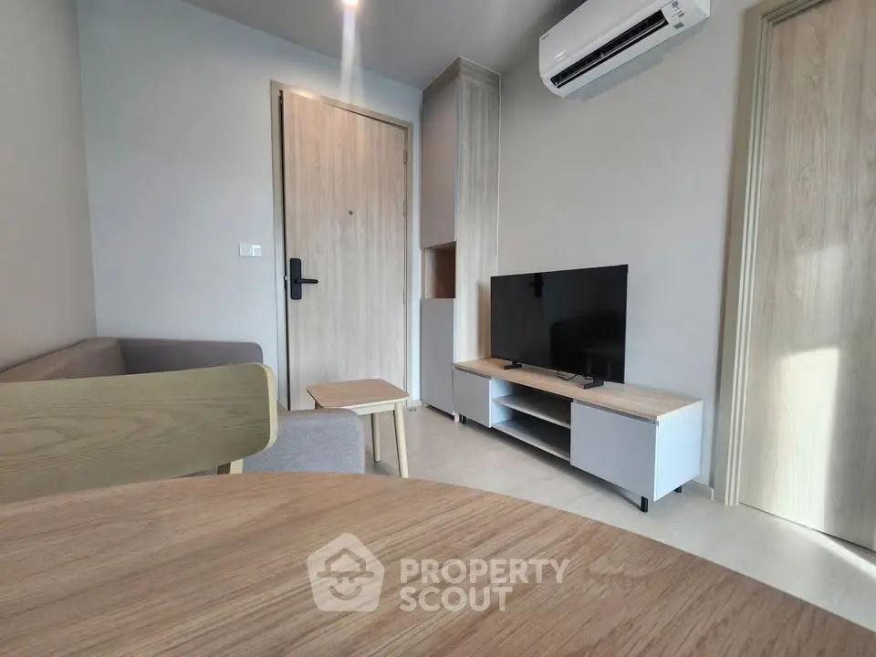 Modern living room with sleek furniture and air conditioning in a stylish apartment.