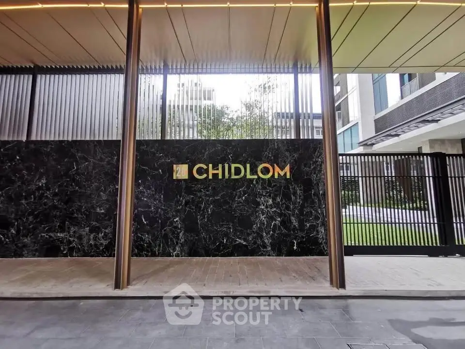 Modern building entrance with sleek design and elegant facade at Chidlom.
