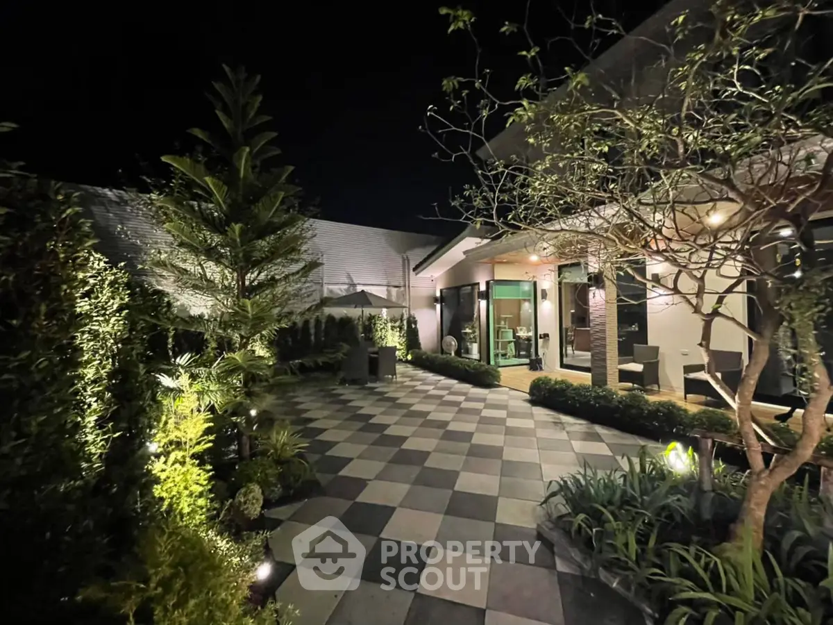 Stunning night view of a modern garden with lush greenery and elegant lighting.