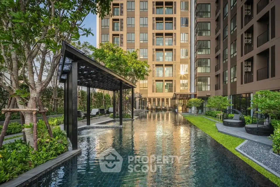 Luxurious apartment complex with stunning pool and lush garden area, perfect for relaxation and leisure.