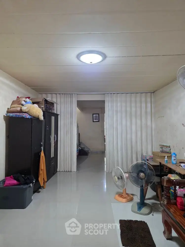 Spacious living area with modern lighting and ample storage space