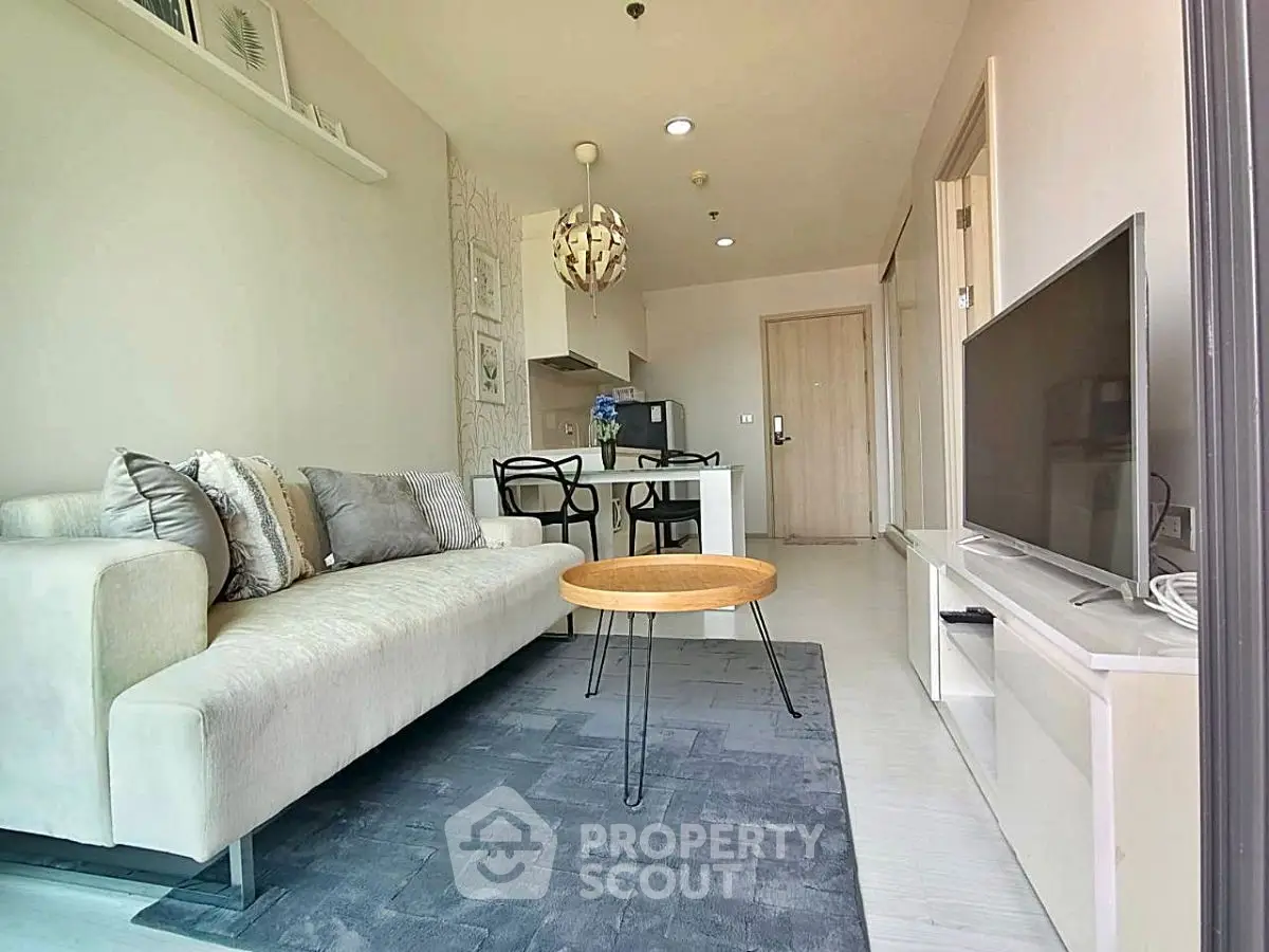 Modern living room with cozy sofa and flat-screen TV in stylish apartment