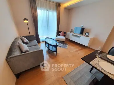 Chic living room with modern decor, cozy seating, and elegant wooden flooring.