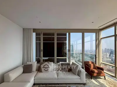 Luxurious living room with panoramic city view and modern furniture in high-rise apartment.