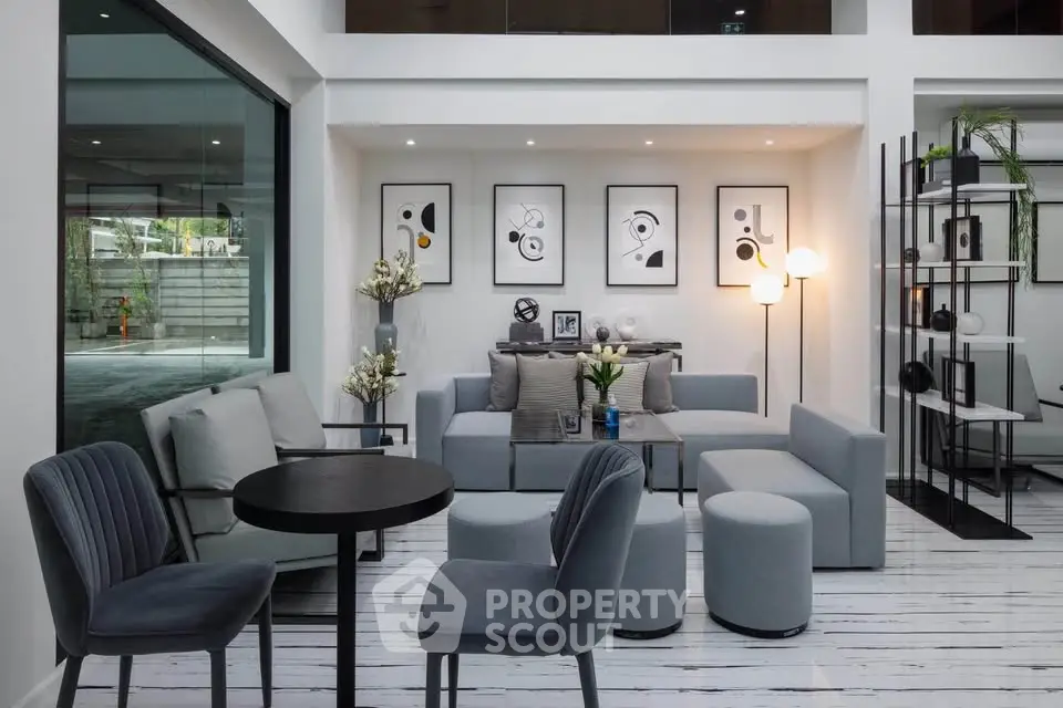 Modern living room with stylish decor and large windows
