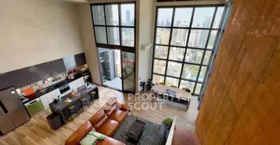 Luxurious high-rise apartment with stunning city views and modern open-plan living area.