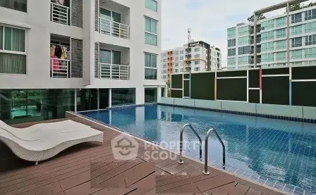 Modern apartment complex with a luxurious outdoor pool and stylish deck area.