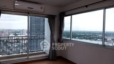 Stunning high-rise apartment with panoramic city and river views from a spacious balcony.
