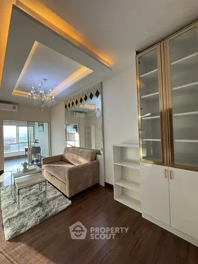 Stylish living room with modern decor and elegant lighting, featuring a cozy sofa and chic shelving.