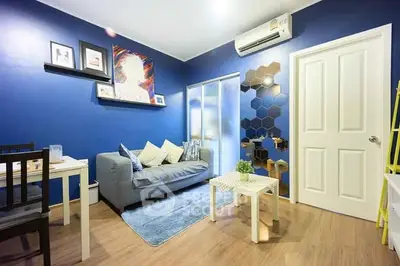 Stylish modern living room with blue walls, cozy sofa, and elegant decor