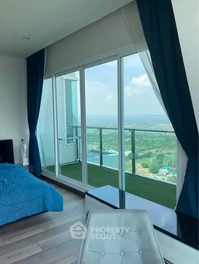 Luxurious bedroom with stunning panoramic view and spacious balcony access.
