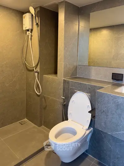Modern bathroom with sleek gray tiles and shower unit