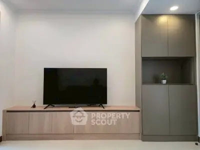 Modern living room with sleek TV unit and stylish cabinetry, perfect for contemporary living.