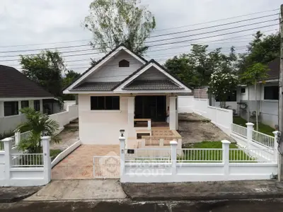 Charming single-story house with fenced yard and tiled patio in a serene neighborhood.