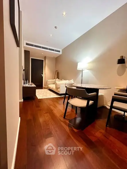 Elegant living room with hardwood floors and modern furniture in a cozy apartment.