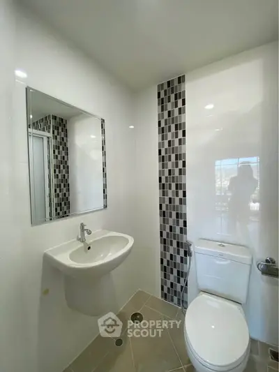 Modern bathroom with stylish tile accents and sleek fixtures