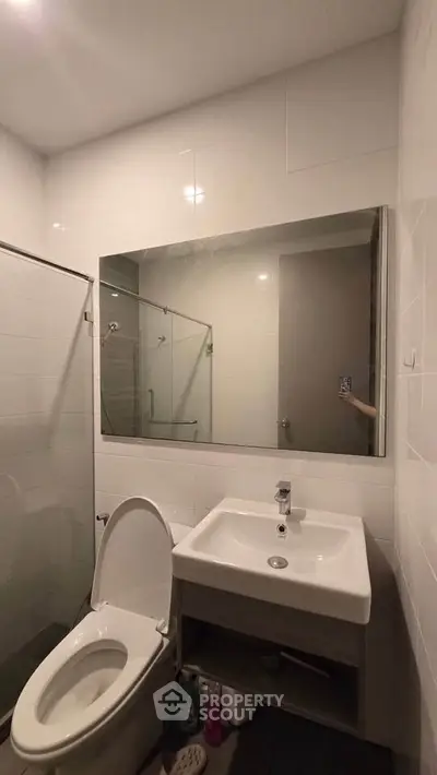 Modern bathroom with sleek fixtures and large mirror