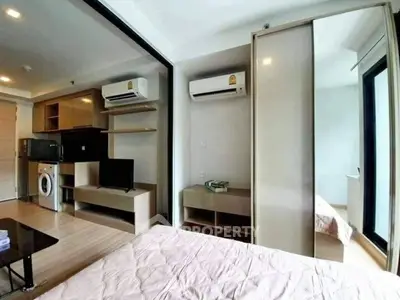 Modern studio apartment with open layout, featuring air conditioning and stylish furnishings.