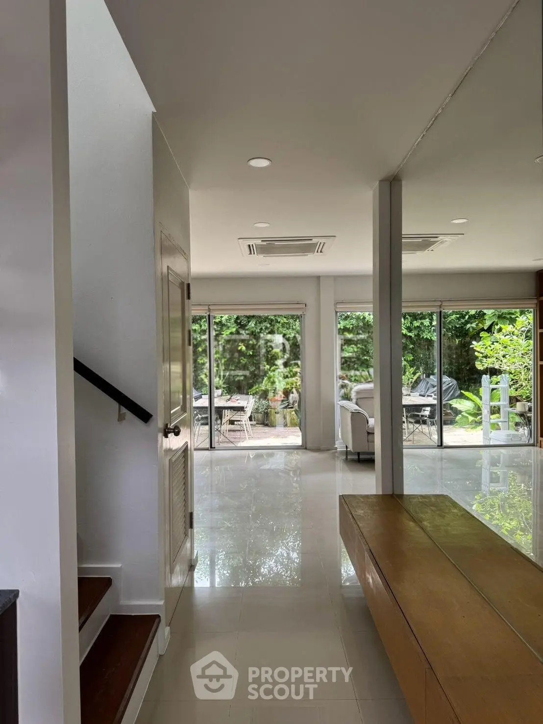 Spacious modern living area with garden view and sleek interior design