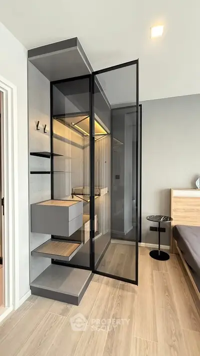 Modern bedroom with sleek glass wardrobe and minimalist design