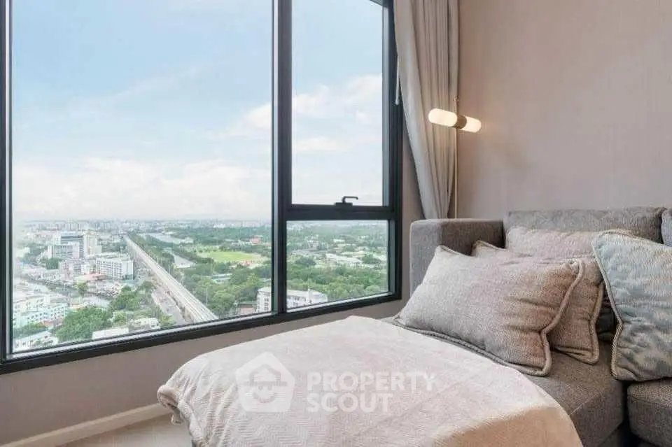 Luxurious living room with panoramic city view from high-rise apartment window.