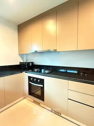 Modern kitchen with sleek cabinetry and built-in oven