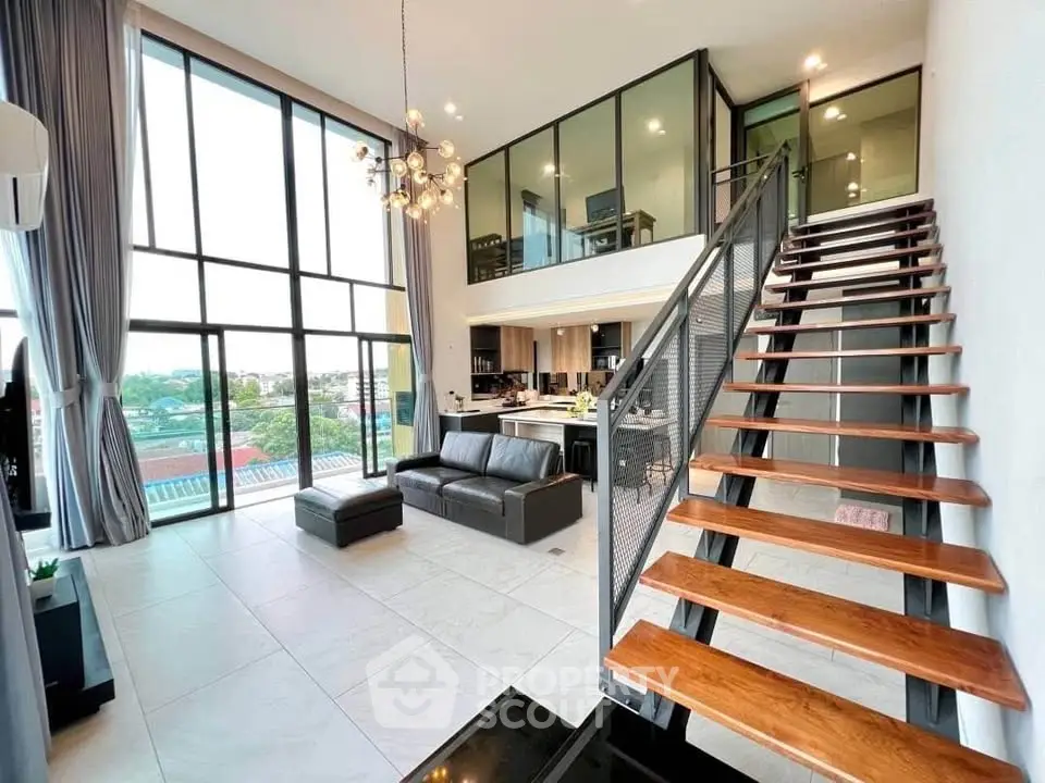 Stunning modern loft with high ceilings and large windows offering panoramic views.