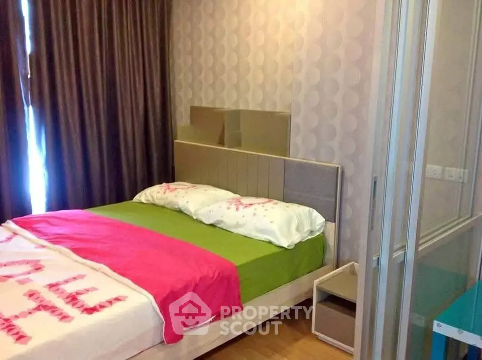 Cozy bedroom with modern decor and vibrant bedding in a stylish apartment.