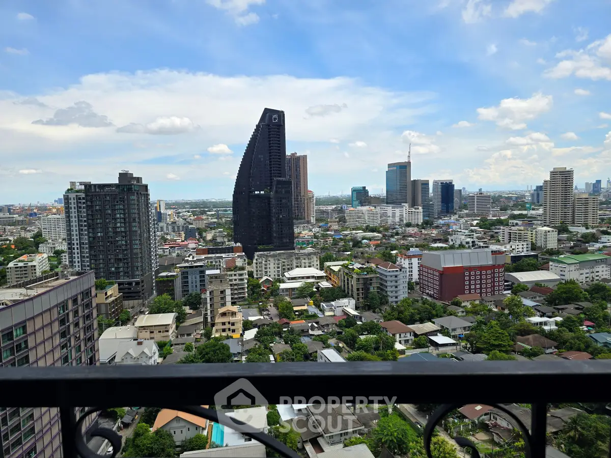 Stunning cityscape view from a high-rise balcony showcasing modern urban architecture and skyline.