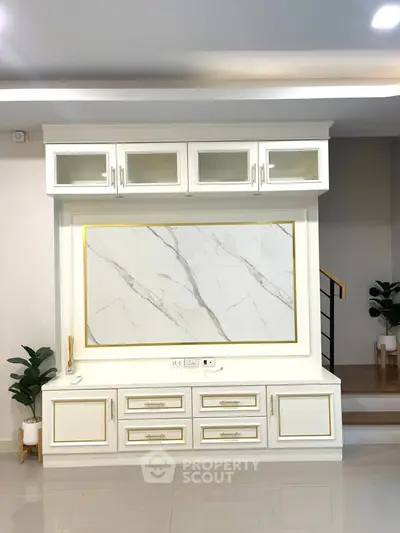 Elegant living room with modern built-in storage and marble accent wall